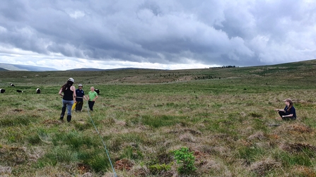 Team members measuring out a monitoring plot in Langstrothdale