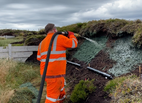 Peatfix substrate being applied to bare peat through a house